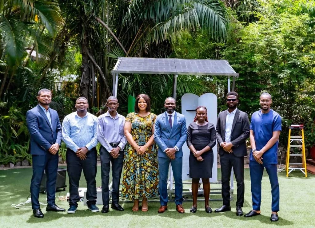 The Anfani team in front of a solar panel installation